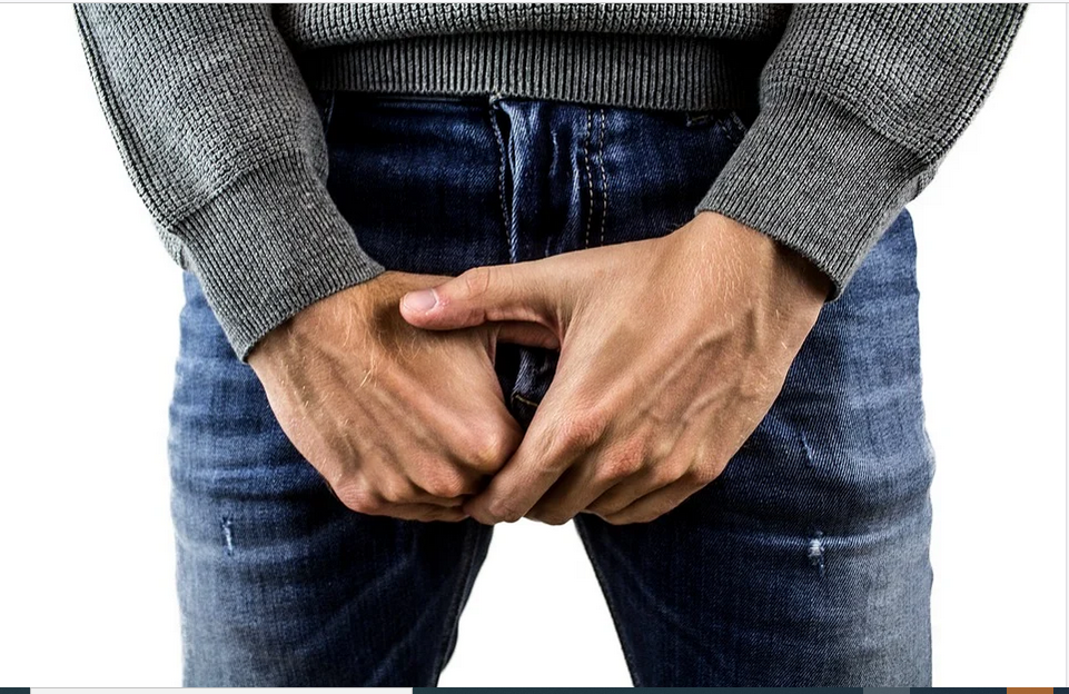 a man with hands in the groins area